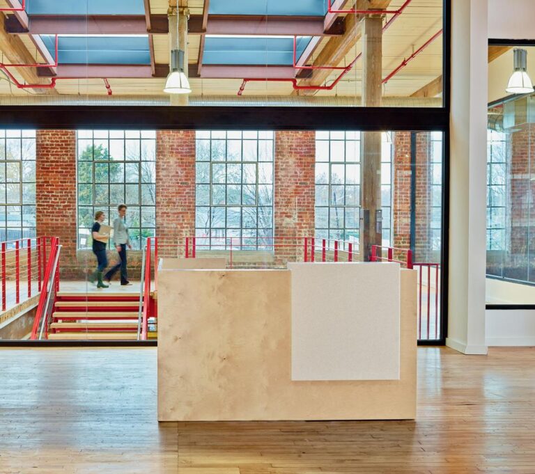 Darran Rail wood reception desk in a brick building