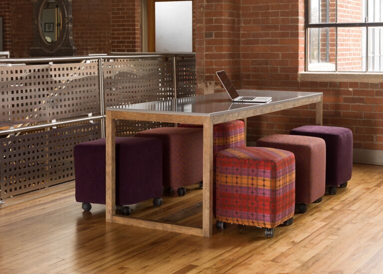 Cabot Wrenn Resolve community table with upholstered stools