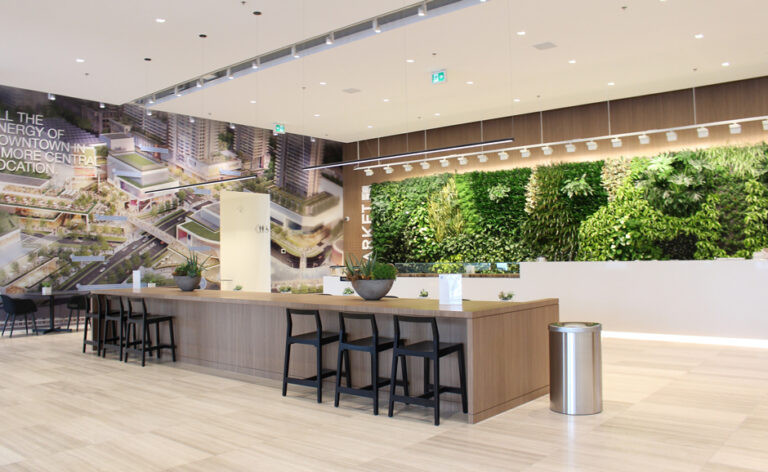 Room B reception counter with a living plant wall