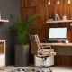 A modern office with plants and a computer desk. Various shelving, including floating shelves and a cabinet on wheels, is present.