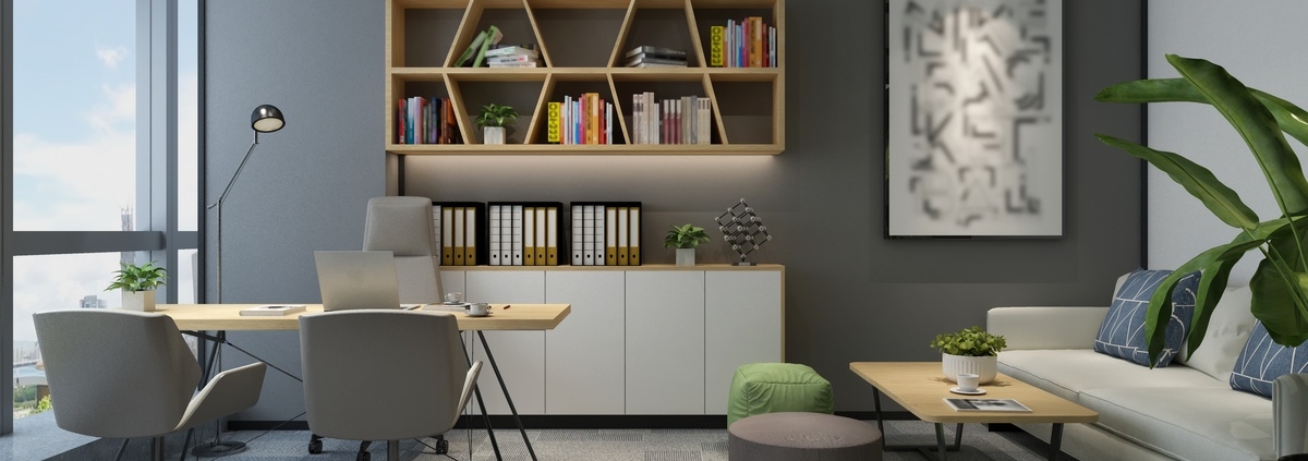 A modern office with a wood desk, gray chairs, a white sofa, green plants, and geometric shelves filled with books.