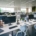 A modern office space with several workspaces spread out. Each desk has a monitor, phone, and chair.